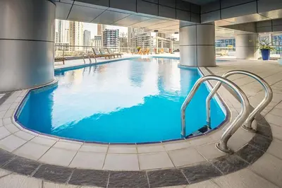 a large pool with blue water in a building at Full Marina and Ain Dubai Wheel View 1BR at The Point Dubai Marina by Deluxe Holiday Homes in Dubai