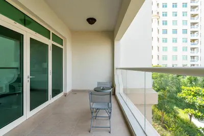 a chair on the balcony of a building at Welcoming 1 Bedroom Palm Jumeirah with sea View in Dubai