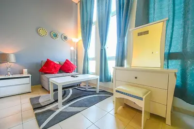 a room with a desk and a table and a couch at Luxury Escapes - Studio near Ibn Battuta Mall & Metro - MOG 193 Discovery Gardens in Dubai