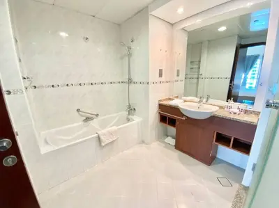 a bathroom with a tub and a sink at Luxury Escapes - Elegant and spacious 1bed with 2 balconies in JLT in Dubai
