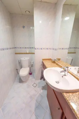 a bathroom with a sink and a toilet at Luxury Escapes - Elegant and spacious 1bed with 2 balconies in JLT in Dubai