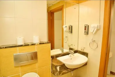a bathroom with a sink and a toilet and a mirror at Luxury Apartments in Dubai marina in Dubai