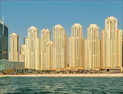 a skyline of a city with a beach and buildings at Luxury Apartments in Dubai marina in Dubai