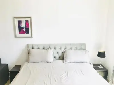 a bedroom with a white bed with white sheets and pillows at Luxury Apartments in Dubai marina in Dubai
