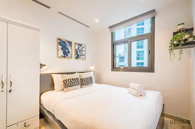 a bedroom with a white bed and a window at Captivating 1BR at DEC Towers Dubai Marina by Deluxe Holiday Homes in Dubai