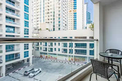 a balcony with a table and chairs and buildings at Captivating 1BR at DEC Towers Dubai Marina by Deluxe Holiday Homes in Dubai