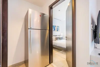 a stainless steel refrigerator in a living room at Captivating 1BR at DEC Towers Dubai Marina by Deluxe Holiday Homes in Dubai