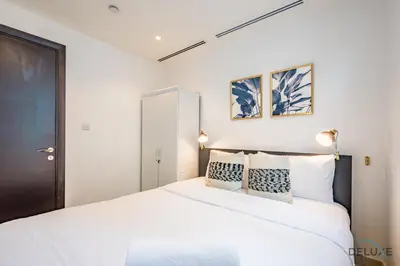 a bedroom with a large white bed with two pillows at Captivating 1BR at DEC Towers Dubai Marina by Deluxe Holiday Homes in Dubai