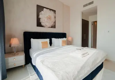 a bedroom with a large bed with a black headboard at Nasma Luxury Stays - Elegant Condo With City Views And Dubai Skyline in Dubai