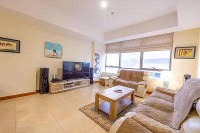 a living room with two couches and a tv at Luxury Escapes - Stylish 1BR - Murad Tower - Close to the Emirates Mall in Dubai