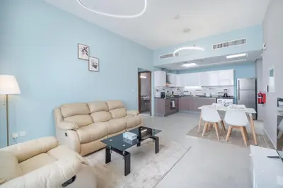 a living room with a couch and a table at Trinity Holiday Homes - Spacious Modern Living 1BR & 2BR Unique Apartment in Dubai