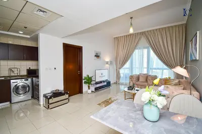 a living room with a couch and a table at Luxury Escapes - 1BR Home with Stunning Marina View - Bay Central Marina in Dubai