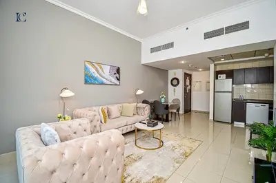 a living room with two couches and a kitchen at Luxury Escapes - 1BR Home with Stunning Marina View - Bay Central Marina in Dubai