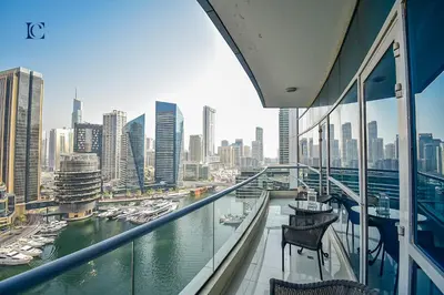 a balcony with a view of a river and a city at Luxury Escapes - 1BR Home with Stunning Marina View - Bay Central Marina in Dubai