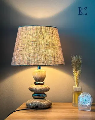 a lamp sitting on a table next to a clock at Luxury Escapes - Lake View Brand New Studio in X1 Tower JLT in Dubai