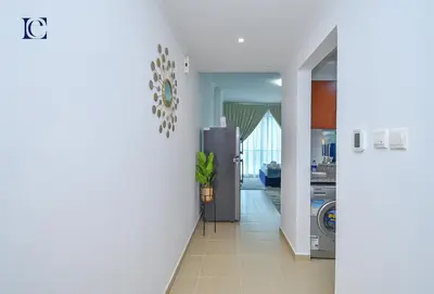 a hallway with a stainless steel refrigerator in a kitchen at Luxury Escapes - Lake View Brand New Studio in X1 Tower JLT in Dubai