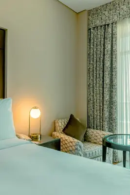 a bedroom with a bed and a couch and a table at TIME Oak Hotel & Suites in Dubai