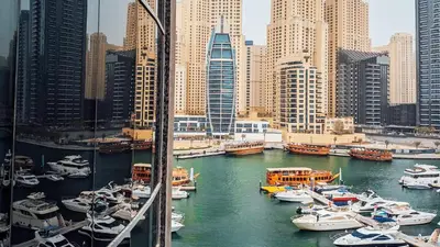 a group of boats in a harbor in a city at Signature Hotel Apartments and Spa in Dubai