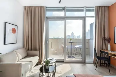 a living room with a couch and a table at Silkhaus modern studio with Burj Khalifa view in DIFC in Dubai