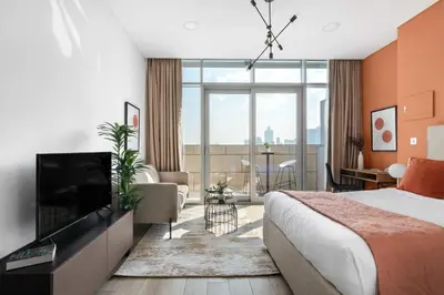 a hotel room with a bed and a television at Silkhaus modern studio with Burj Khalifa view in DIFC in Dubai