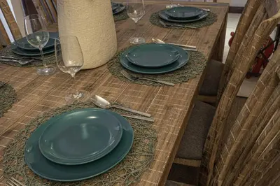 a table with green plates and wine glasses on it at HiGuests - Spacious Apartment Close to Dubai Marina Walk in Dubai