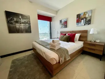 a bedroom with a bed with a stuffed animal on it at HiGuests - Spacious Apartment Close to Dubai Marina Walk in Dubai