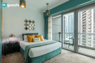 a bedroom with a bed and a large window at HiGuests - Royal 2BR Apt with Maid's Room Near Burj Khalifa in Dubai