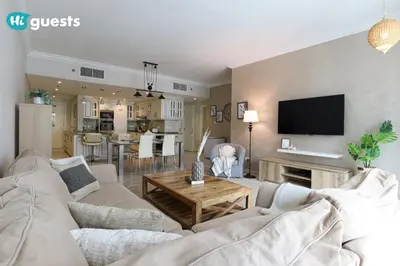 a living room with a couch and a table at HiGuests - Royal 2BR Apt with Maid's Room Near Burj Khalifa in Dubai