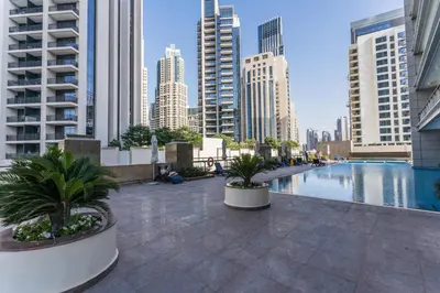 a swimming pool in a city with tall buildings at HiGuests - Royal 2BR Apt with Maid's Room Near Burj Khalifa in Dubai