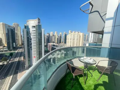 a balcony with two chairs and a table on top of a building at Luxury Room with Marina view close to JBR Beach and Metro with Shared Kitchen in Dubai