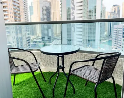 a table and two chairs on a balcony with a view at Luxury Room with Marina view close to JBR Beach and Metro with Shared Kitchen in Dubai