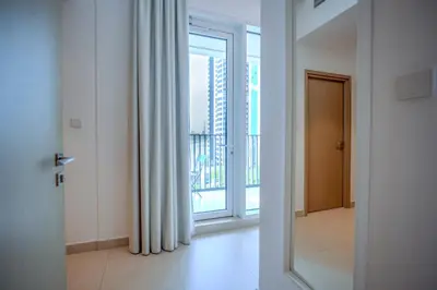 a door to a room with a window and a balcony at 3BR Haven with Burj Views by MagnoliasVHR in Dubai