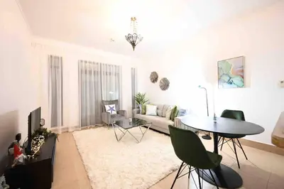 a living room with a table and a couch at Brand new furniture . Close to Dubai Mall. in Dubai