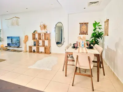 a dining room with a table and a mirror at Wonderful two bed room with full marina view in Dubai
