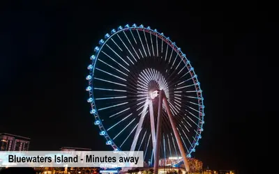 a large ferris wheel is lit up at night at Luxury Escapes - Cozy Studio with Balcony near Metro - Goldcrest 2 JLT in Dubai