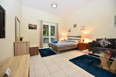 a living room with a bed and a couch at Luxury Escapes - Budget-Friendly Studio Near Metro - MED67 DG in Dubai