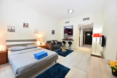 a bedroom with a bed and a living room at Luxury Escapes - Budget-Friendly Studio Near Metro - MED67 DG in Dubai