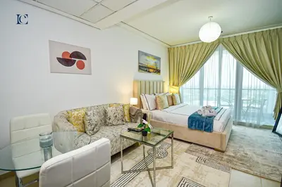 a hotel room with a bed and a couch at Brand New Studio Apt - Near JLT Metro in Dubai