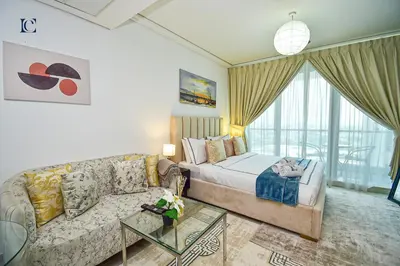 a living room with a bed and a couch at Brand New Studio Apt - Near JLT Metro in Dubai