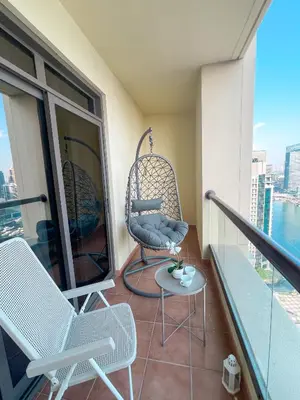 a balcony with two chairs and a table at Apartments on JBR by HAPPY SEASON in Dubai