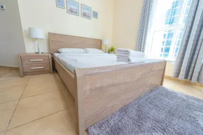 a bedroom with a large bed with towels on it at Luxury Escapes - Modern Budget studio with balcony in JLT! in Dubai