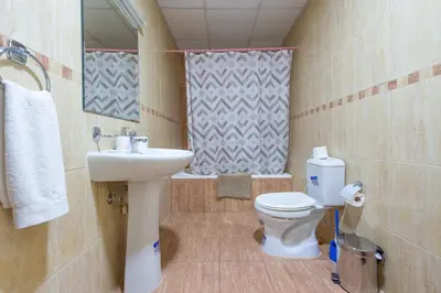 a bathroom with a sink and a toilet and a mirror at Luxury Escapes - Modern Budget studio with balcony in JLT! in Dubai
