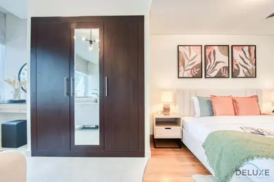 a bedroom with a bed and a sliding glass door at Charming Studio at Sky Gardens DIFC by Deluxe Holiday Homes in Dubai