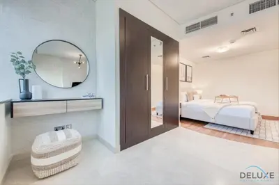a bedroom with a bed and a mirror at Special Rate Cozy Studio with Balcony Near Attractions by Deluxe Holiday Homes in Dubai