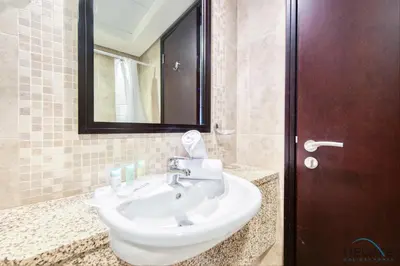 a bathroom with a white sink and a mirror at Special Rate Cozy Studio with Balcony Near Attractions by Deluxe Holiday Homes in Dubai