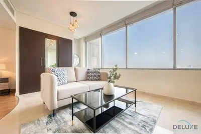 a living room with a couch and a glass table at Oceanic Studio at Sky Gardens DIFC by Deluxe Holiday Homes in Dubai