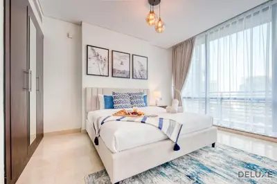a bedroom with a bed and a large window at Tranquil Studio at Sky Gardens DIFC by Deluxe Holiday Homes in Dubai