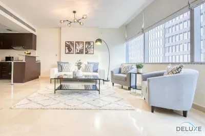 a living room with two couches and a table at Gorgeous 1BR at Sky Gardens, DIFC by Deluxe Holiday Homes in Dubai