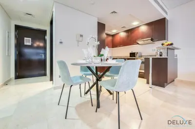 a kitchen with a table and chairs in a room at Gorgeous 1BR at Sky Gardens, DIFC by Deluxe Holiday Homes in Dubai