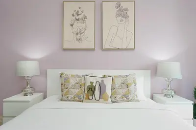 a bedroom with a white bed with two lamps at Marco Polo - Your luxurious high-floor escape in Dubai Marina in Dubai